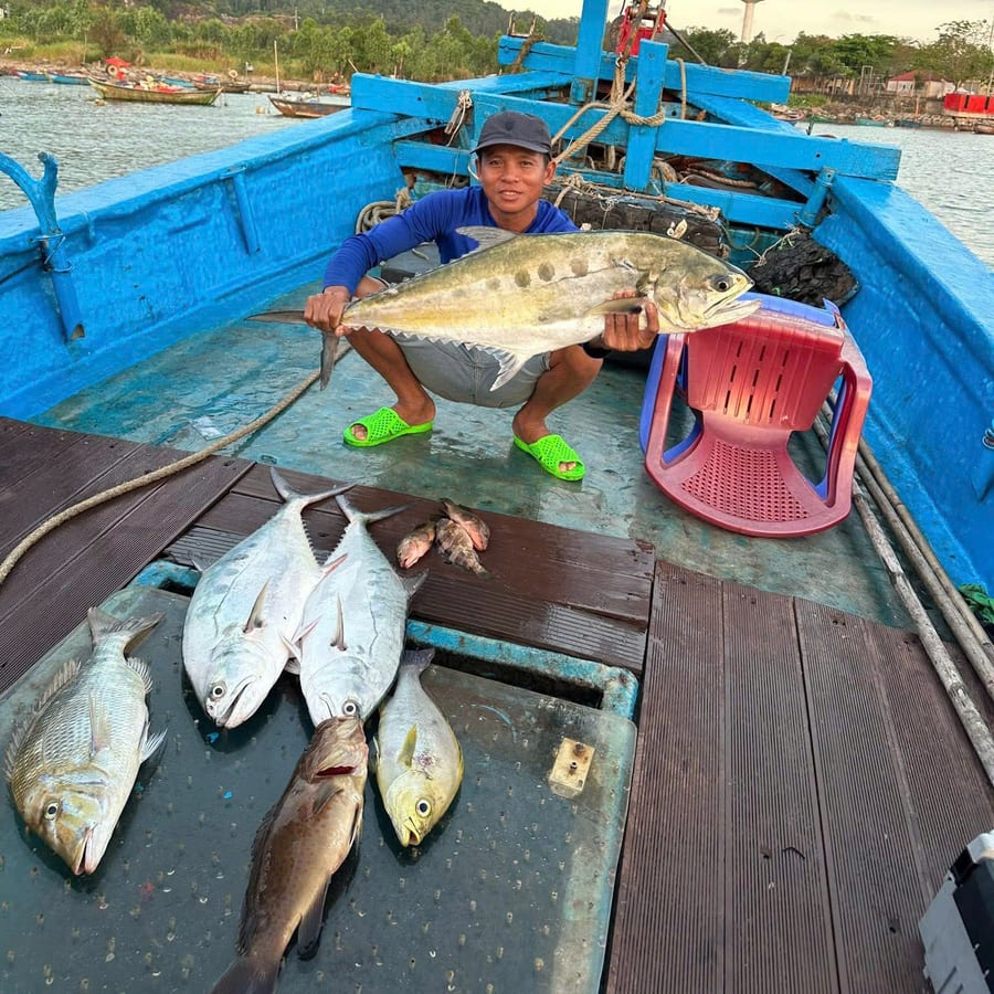 Local crew member on deck with the day catch off Phu Quoc