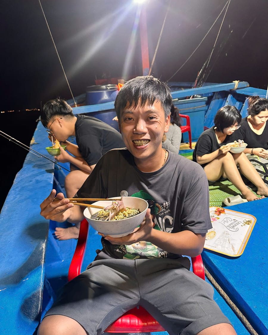 Guest eating a meal on board during a night fishing trip