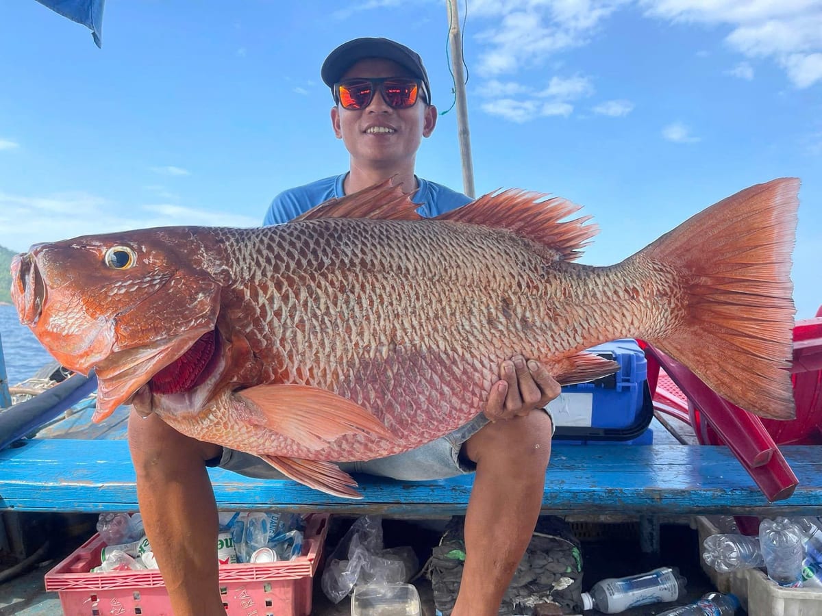 Guest holding a large red snapper caught on a big game fishing trip in Phu Quoc
